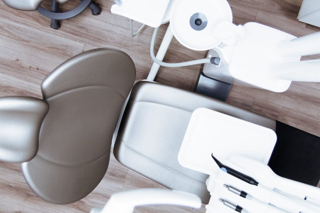 pexels photo 305564 High-angle view of a modern dental chair and equipment setup in a professional clinic.